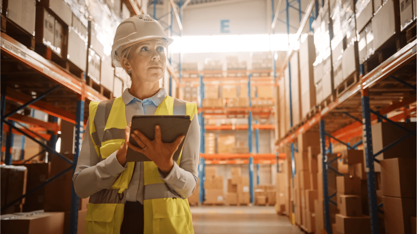 women in a factory on an ipad