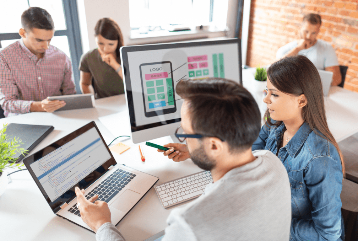 workers on laptops in an office - Intellisell Integration